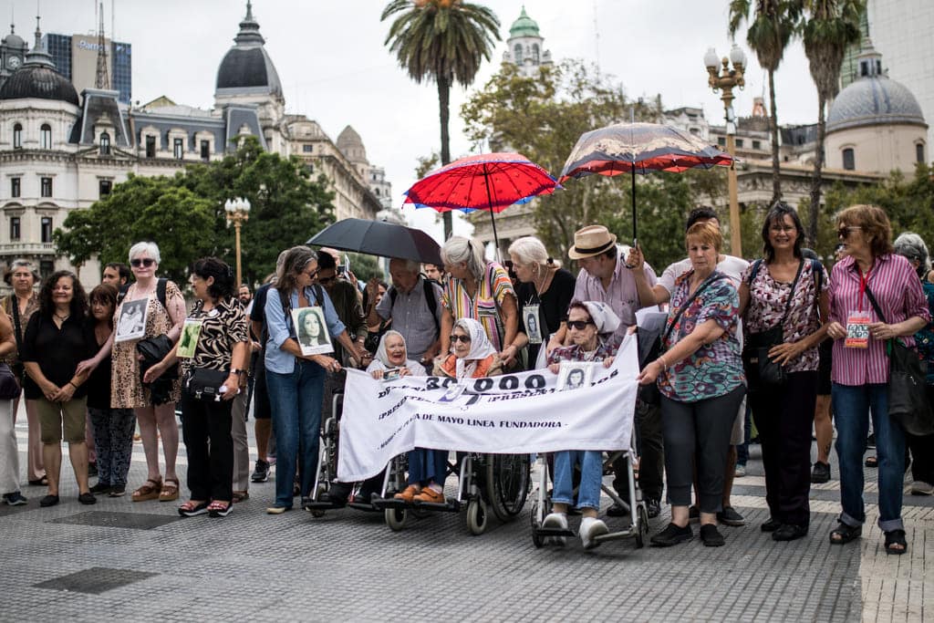 Fotografía de la bandera con todos los retratos de los desaparecidos.